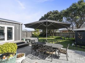 A garden with a table and chairs under an umbrella at the property