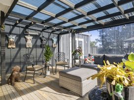 A conservatory with seating and plants at the property in location