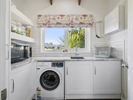 A laundry room with a washing machine and a sink at The Old Barn in Manchester