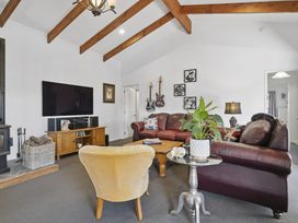 A living room with a leather couch and television at The Old Barn in Manchester