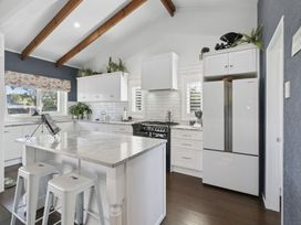 A kitchen with white cabinets and appliances at 