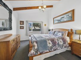 A bedroom with a bed and wooden furniture at The Old Barn in Manchester