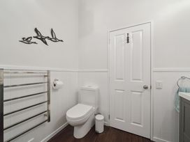 A bathroom with a toilet and towel rack at the property in location