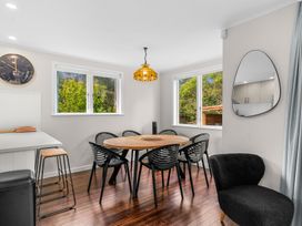 A dining room with a table and chairs at Taotahi Hideaway - Ruakaka