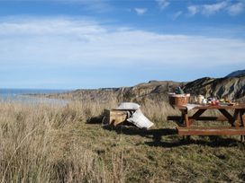 A picnic setup on a grassy area at Dunluce Coastal Farmstay - Kaikoura Holiday Home Kaikoura