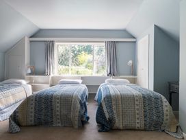 A bedroom with two beds and a window at Dunluce Coastal Farmstay - Kaikoura Holiday Home