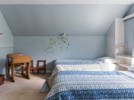 A bedroom with two beds and a desk at Dunluce Coastal Farmstay - Kaikoura Holiday Home