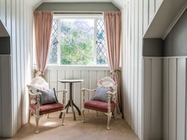 A sitting area with chairs and a table at Dunluce Coastal Farmstay - Kaikoura Holiday Home