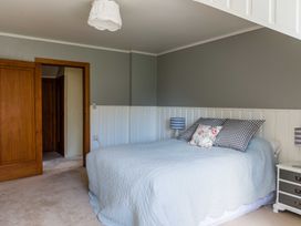 A bedroom with a bed and bedside table at Dunluce Coastal Farmstay - Kaikoura