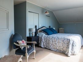 A bedroom with a bed and nightstand at Dunluce Coastal Farmstay - Kaikoura Holiday Home