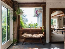 A seating area with plants and a view at Dunluce Coastal Farmstay - Kaikoura Holiday Home