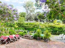 A garden with flowers and seating at Dunluce Coastal Farmstay - Kaikoura