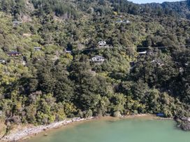 A view of houses and trees along a shore at Charlotte's Cottage - Havelock Holiday Home Marlborough