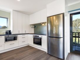 A kitchen with a refrigerator, microwave, and oven at Charlotte's Cottage - Havelock Holiday Home Marlborough
