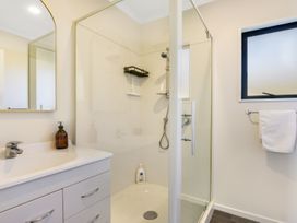 A bathroom with a shower and sink at Charlotte's Cottage - Havelock Holiday Home Marlborough