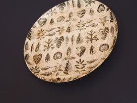 A decorative plate with leaf patterns