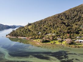 An aerial view of houses near a body of water and a mountain at Koraha Serenity - Linkwater Holiday Home Marlborough