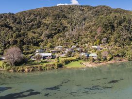 A view of houses near water surrounded by trees at Koraha Serenity - Linkwater Holiday Home Marlborough