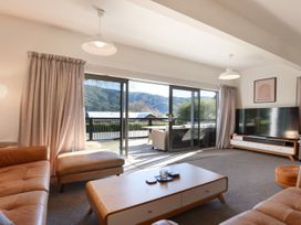 A living room with a sofa and television at Koraha Serenity - Linkwater Holiday Home, Marlborough