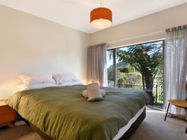 A bedroom with a bed and window at Koraha Serenity - Linkwater Holiday Home Marlborough
