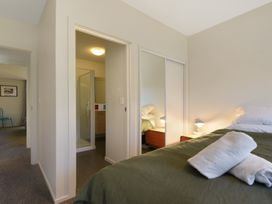A bedroom with a bed and nightstand at Koraha Serenity - Linkwater Holiday Home Marlborough