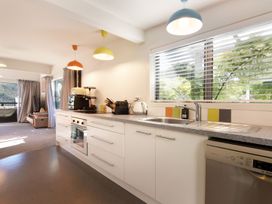 A kitchen with modern appliances and a window at Koraha Serenity - Linkwater Holiday Home Marlborough