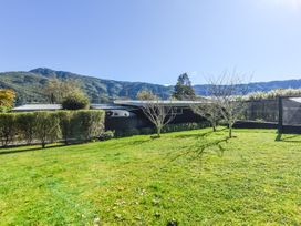An outdoor area with grass and trees at Koraha Serenity - Linkwater Holiday Home in Marlborough