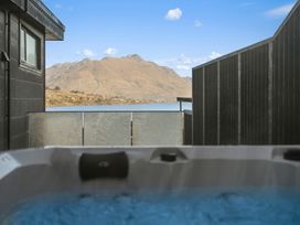 A hot tub view with mountains and lake at Remarkable QT - Queenstown