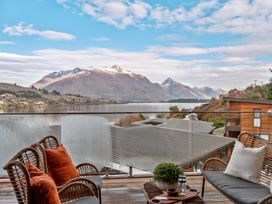 A seating area with a view of the mountains and lake at Remarkable QT - Queenstown Holiday Home