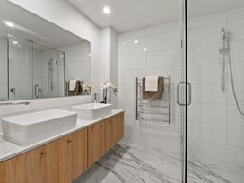 A bathroom with sinks and a shower at Remarkable QT - Queenstown Holiday Home
