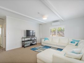 A living room with a couch and television at the property in location