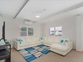 A living room with a sectional sofa and a television at The Old Barn in Manchester