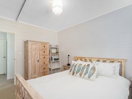 A bedroom with a bed and wardrobe at The Old Barn in Manchester