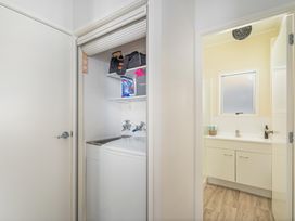 A laundry room with a washing machine and sink at The Old Barn in Manchester