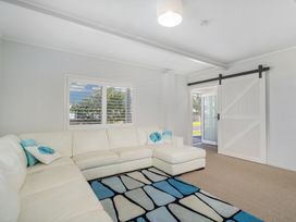 A living room featuring a sofa, rug, and door at The Old Barn in Manchester