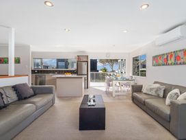 A living room with a kitchen island and dining area at a property in an unspecified location