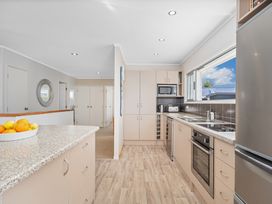 A kitchen with appliances and a fruit bowl at a property