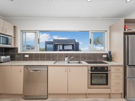 A kitchen with appliances and a window at The Old Barn in Manchester