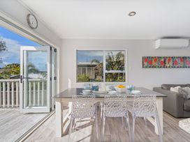 A dining room with a table and chairs at the property in the location
