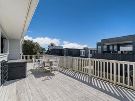 An outdoor area with a table and chairs on a deck at the property