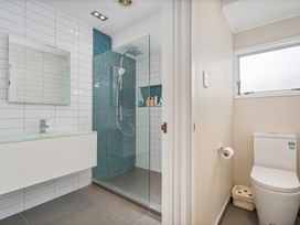 A bathroom with a shower and toilet at 