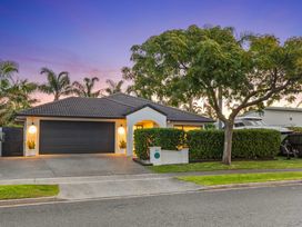 A house with a garage and driveway at JB's Sanctuary - Papamoa Holiday Home, Papamoa
