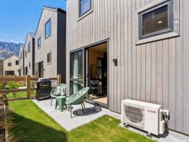 An outdoor area with seating chairs and a grill at Pinnacle Peaks - Queenstown Holiday Home, Queenstown