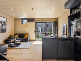 A living room with a sofa and coffee table at Pinnacle Peaks - Queenstown Holiday Home, Queenstown