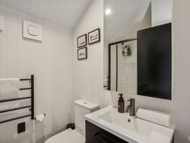 A bathroom with a sink and toilet at Pinnacle Peaks - Queenstown Holiday Home in Queenstown