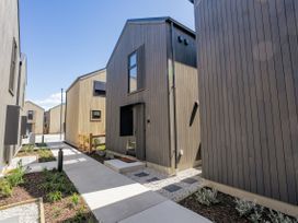 A pathway between houses at Pinnacle Peaks - Queenstown Holiday Home, Queenstown