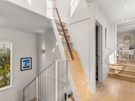 A staircase with railing and window at Oli Kai - Algies Bay Holiday Home in Algies Bay