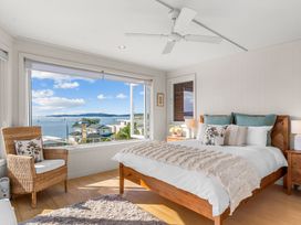 A bedroom with a bed and a view at Oli Kai - Algies Bay Holiday Home, Algies Bay