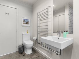 A bathroom with a toilet and sink at Oli Kai - Algies Bay Holiday Home, Algies Bay