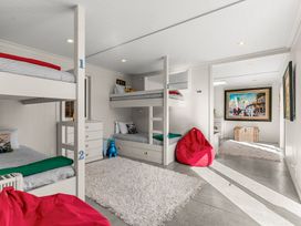 A bedroom with bunk beds and bean bags at Oli Kai - Algies Bay Holiday Home in Algies Bay